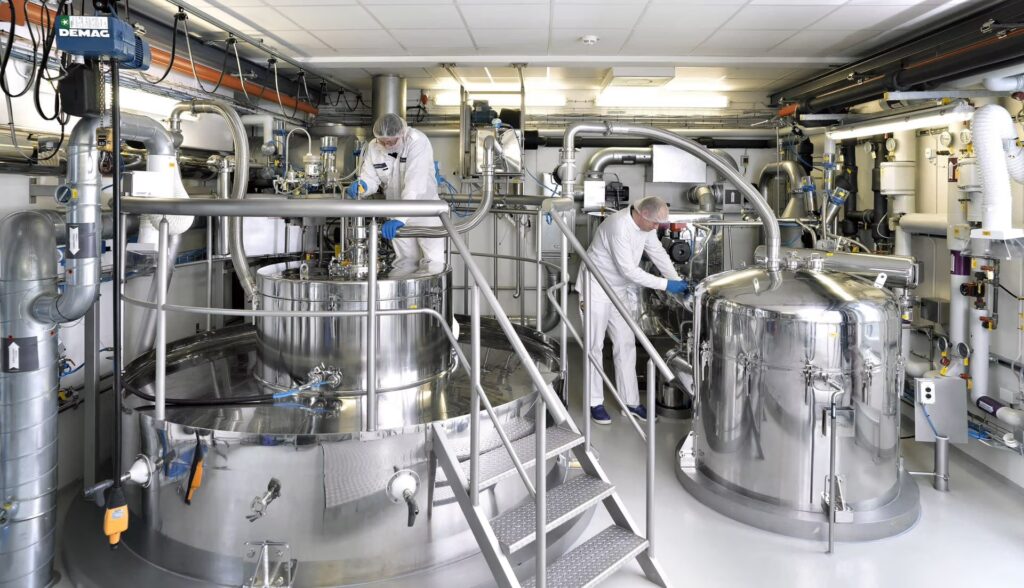 AtomMek engineering team installing a stainless steel reactor at client facility